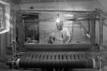 Artisan working on fabric loom