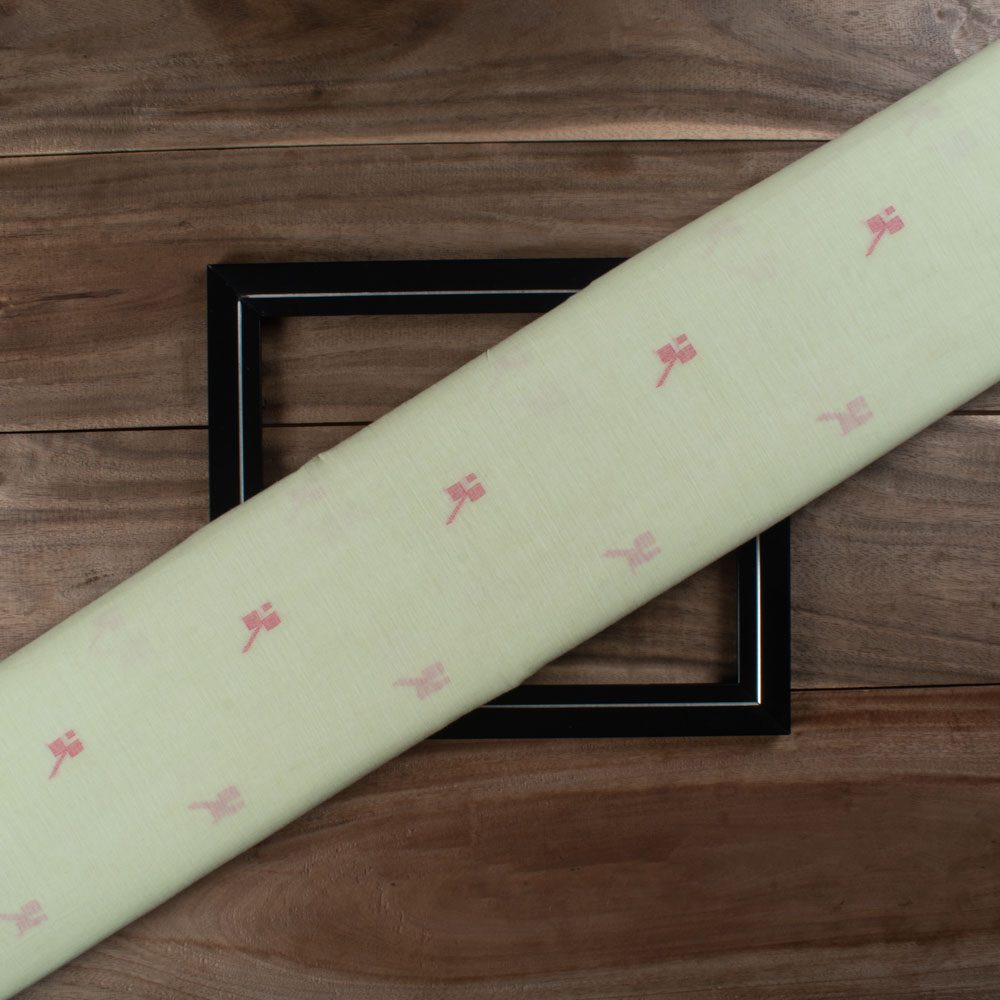 Green plain cotton Jamdani fabric with red geometric motif folded for product display