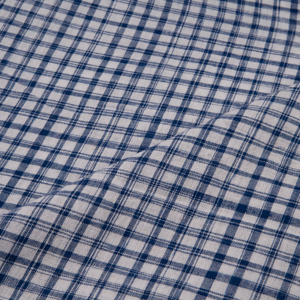 Navy and white tie-dye fabric with a check pattern