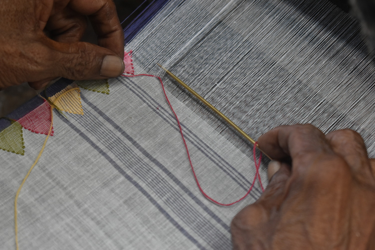 Fabric getting embroidered by hand