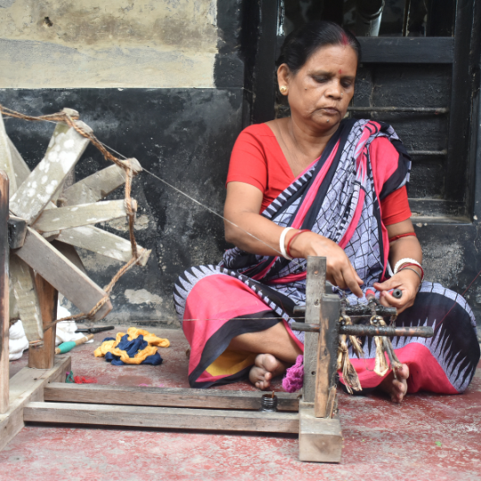Women weaver weaving fabric