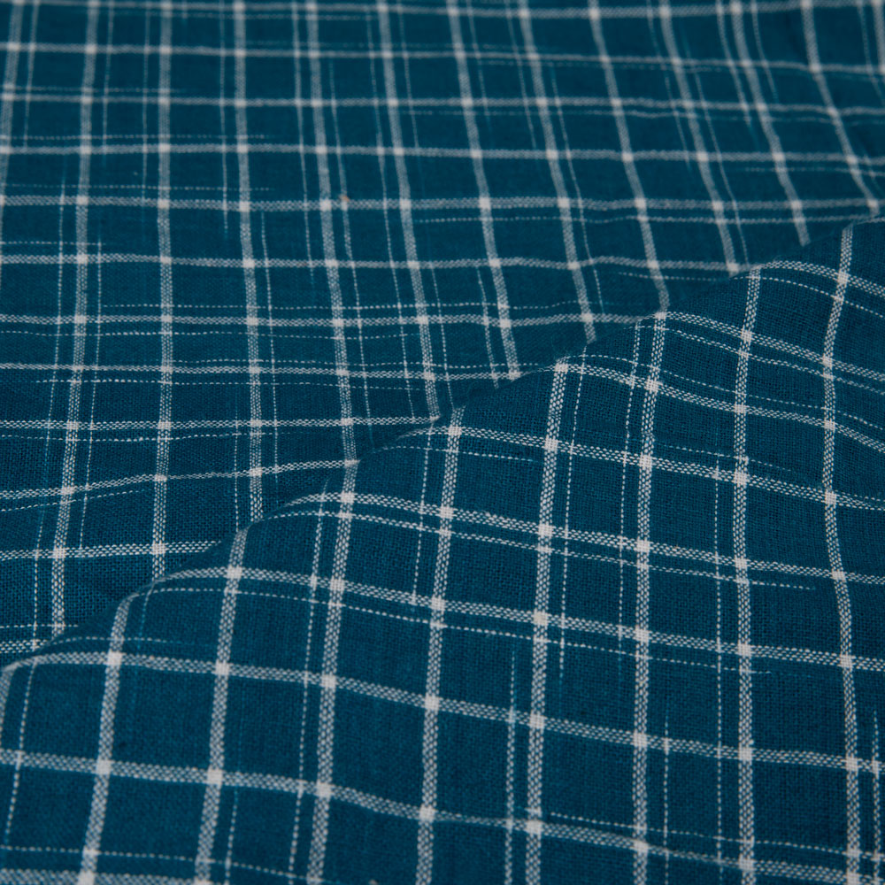 Teal tie-dye fabric with a check pattern
