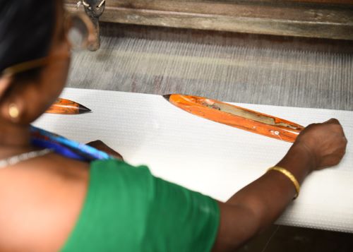 Women artisan weaving fabric