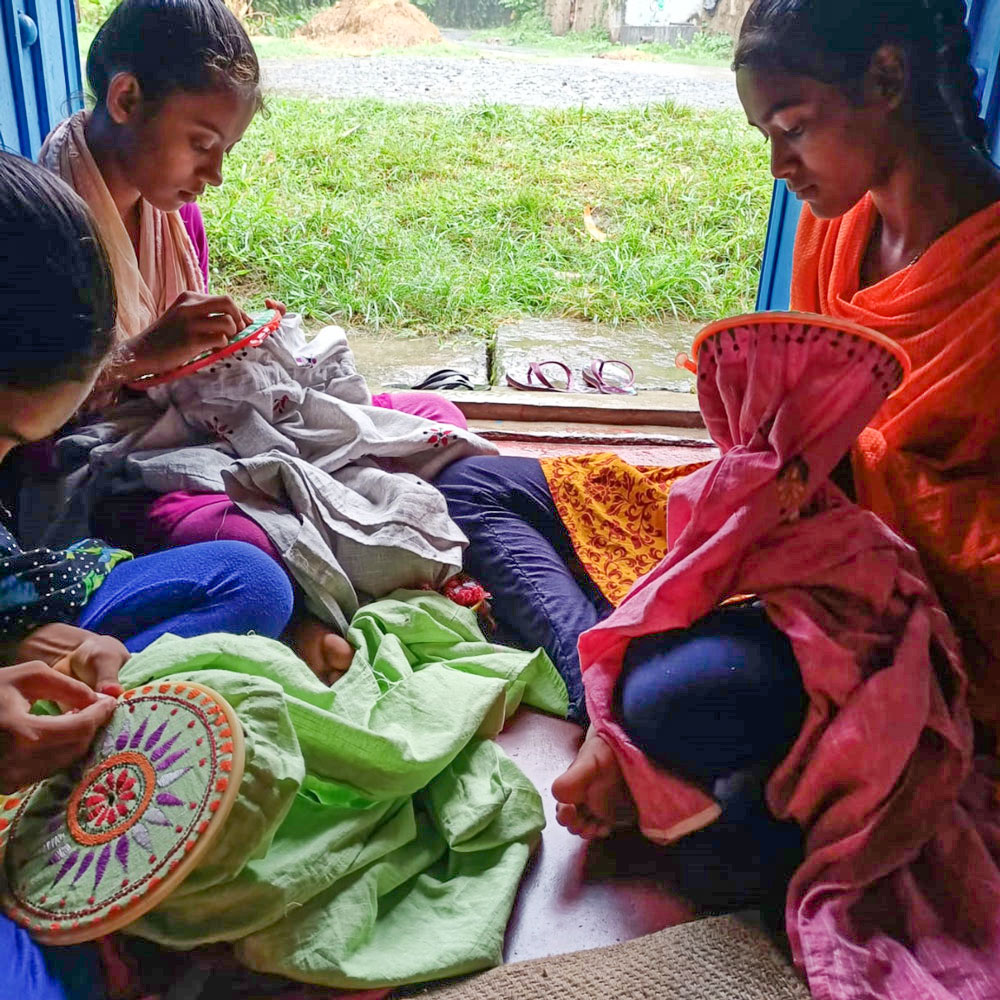 Artisans Weaving Kantha Embroidery on Fabric