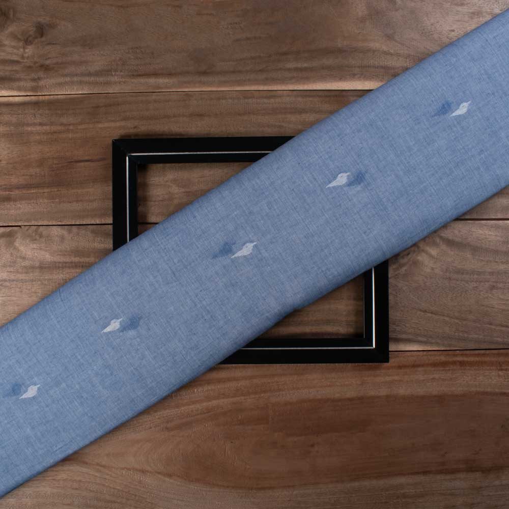 Blue plain cotton Jamdani fabric with white and blue bird motif folded for product display