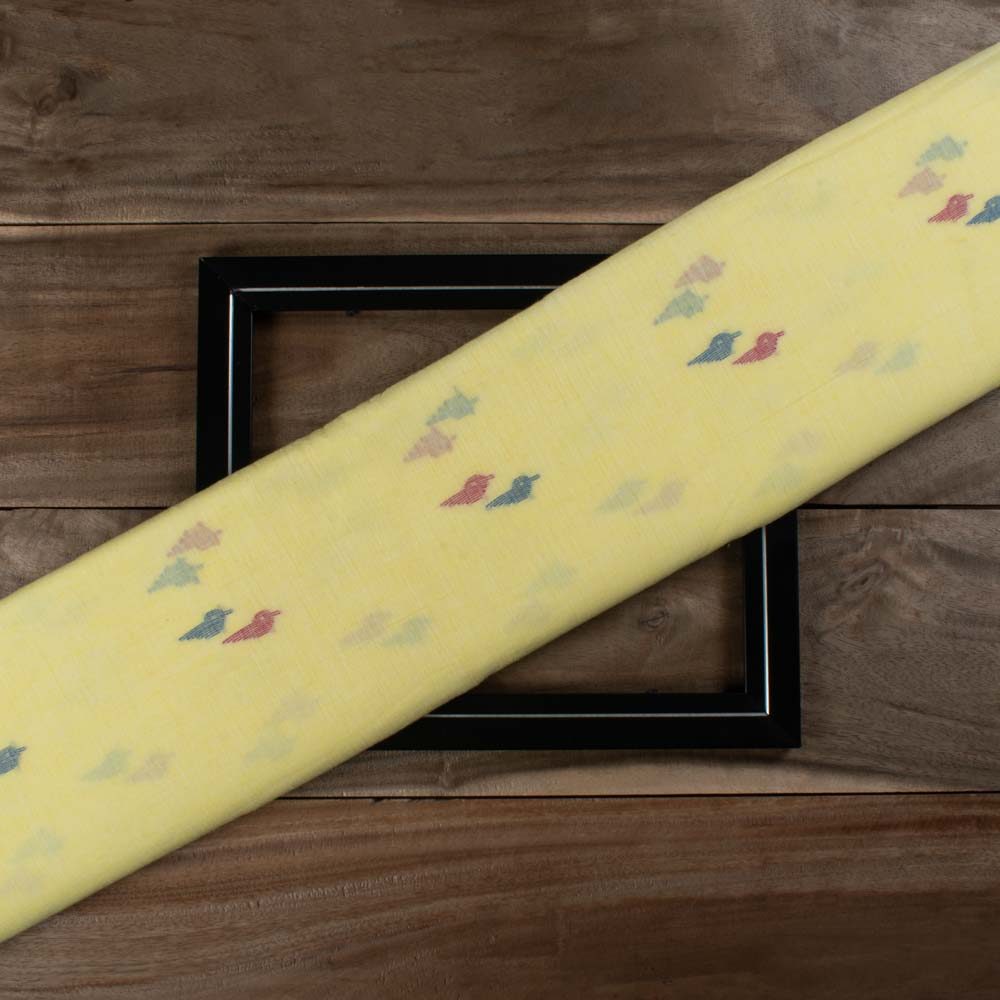 Yellow plain cotton Jamdani fabric with red and blue bird motif folded for product display