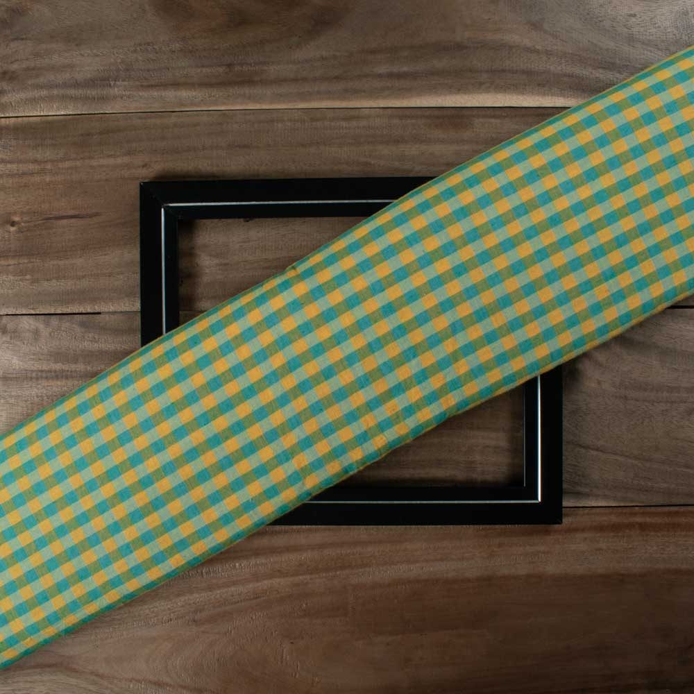 Yellow and green check cotton fabric displayed folded for product showcase